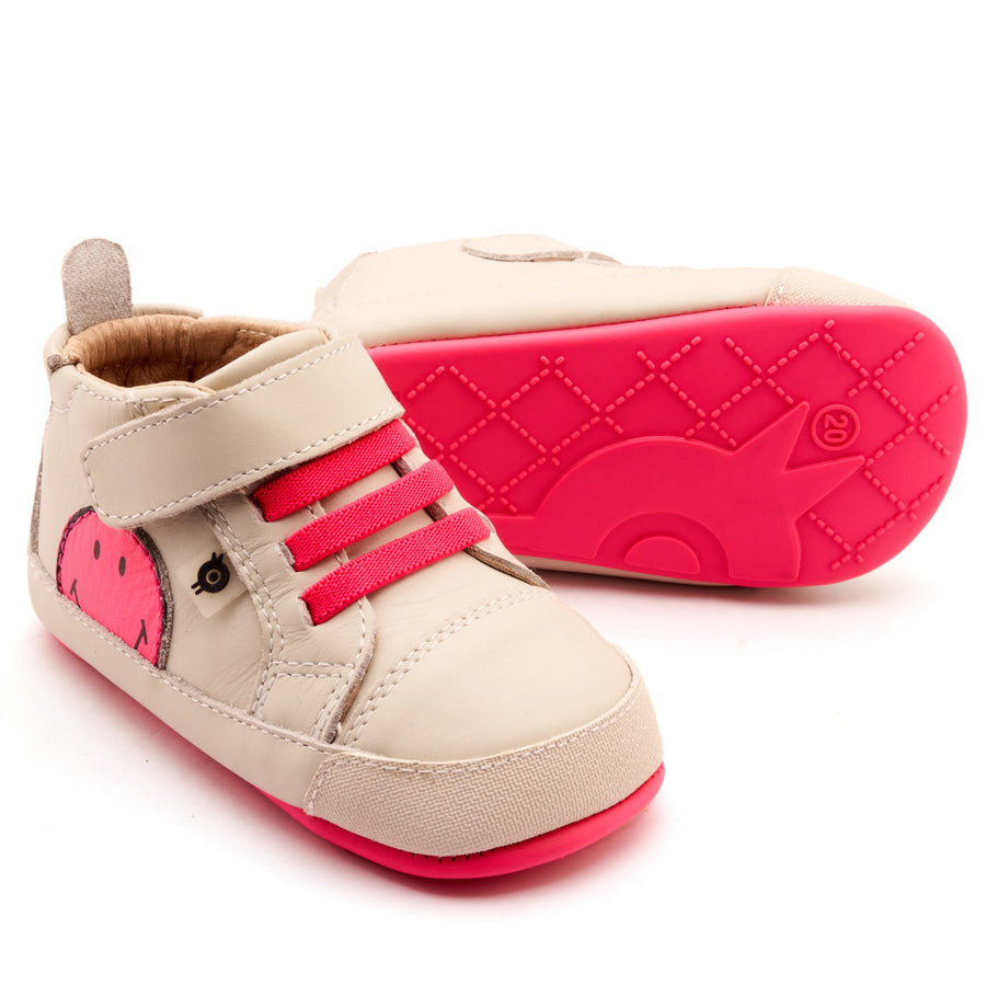 Beige and pink children's shoes on a white background