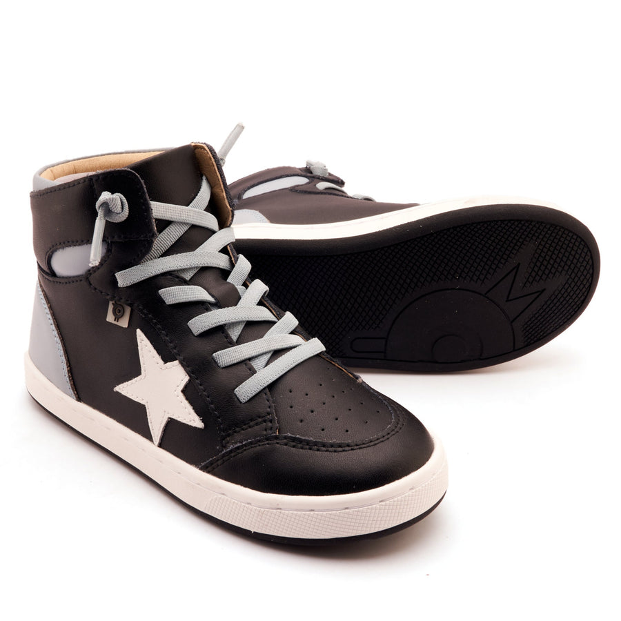 Black high-top sneakers with white star on a white background