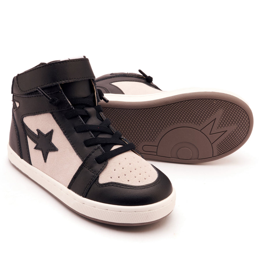 Black and white high-top sneakers with a star design on a white background