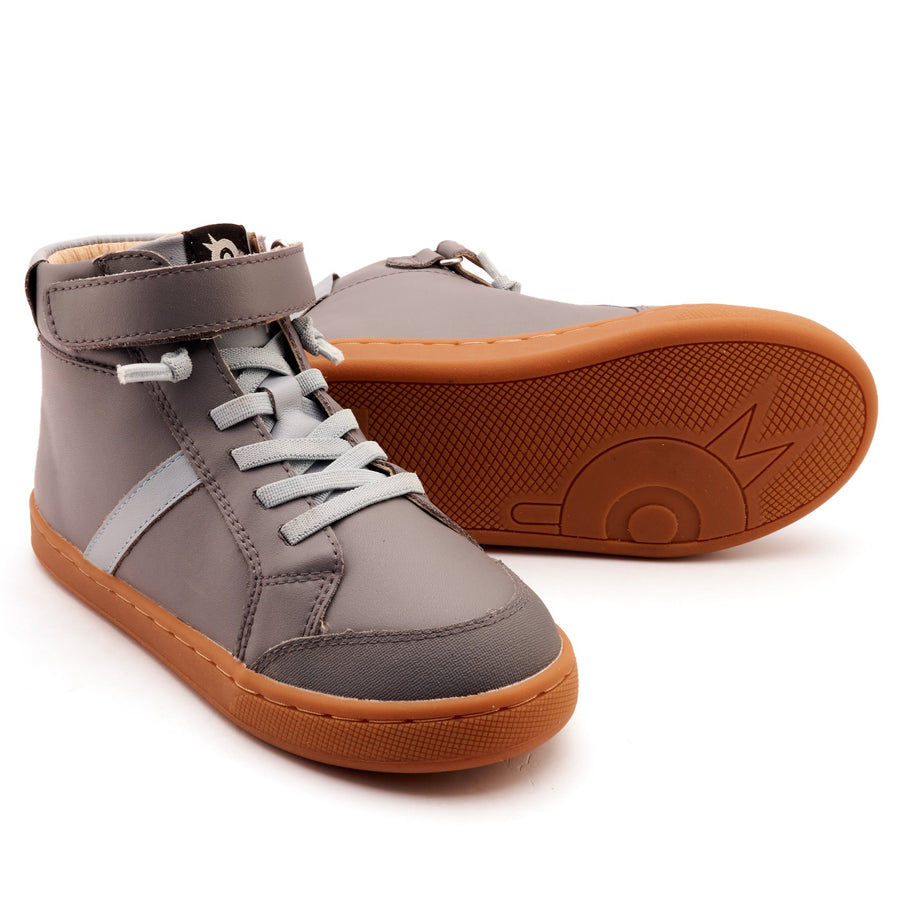 Pair of gray high-top sneakers with brown soles on a white background