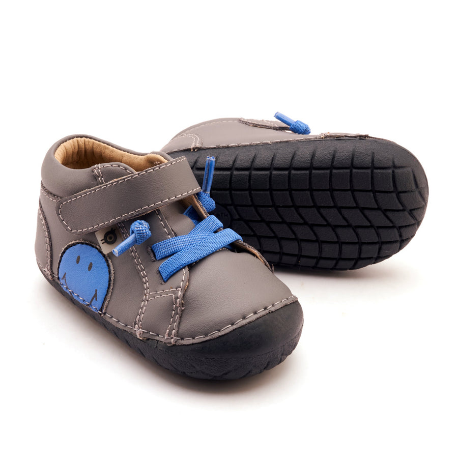 Pair of children's shoes with blue accents on a white background