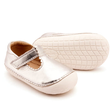Pair of baby shoes with metallic sole on a white background
