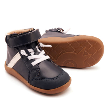 Pair of black and brown children's shoes with white laces on a white background