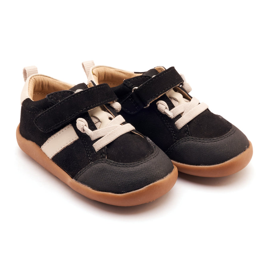 Pair of black and brown children's shoes on a white background