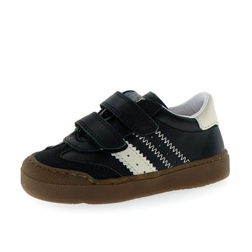 Black and white sneaker with a brown sole on a white background