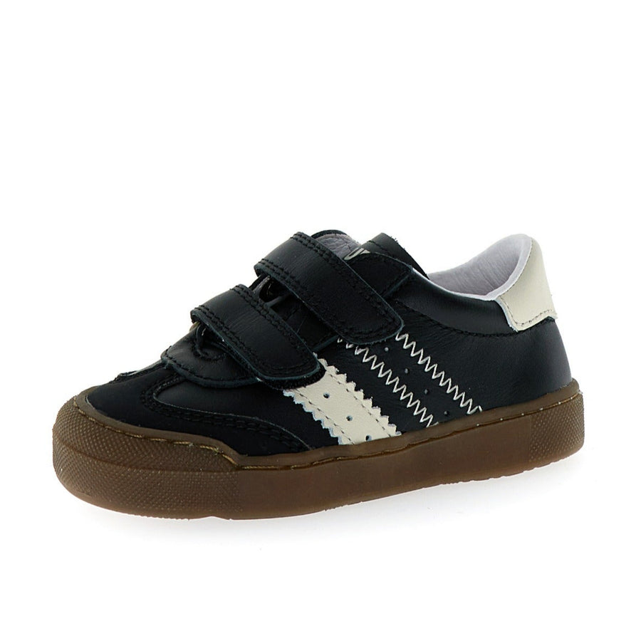 Black and white sneaker with a brown sole on a white background