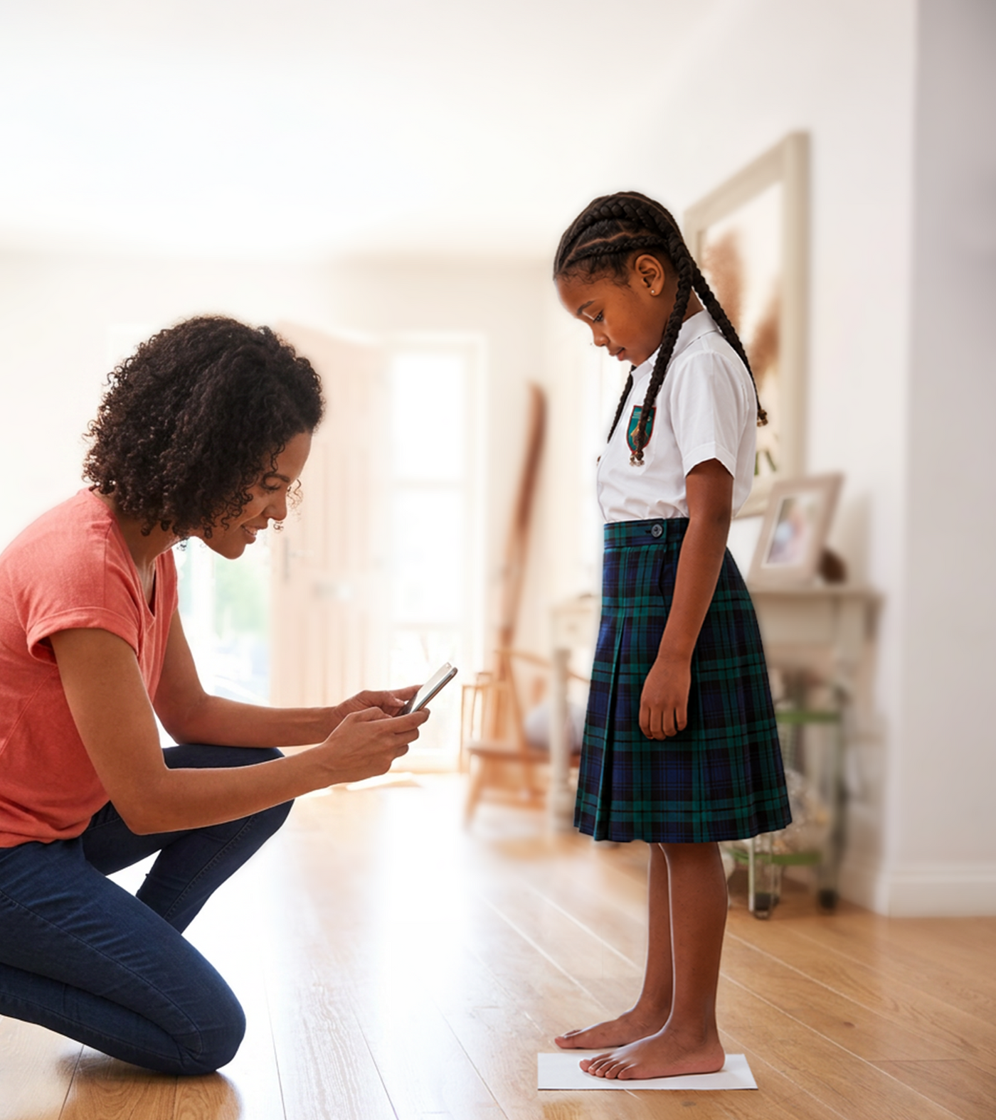 A parent scanning a child's feet with a phone